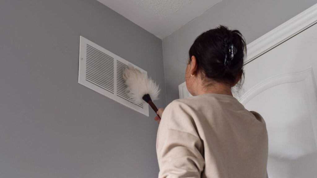 a homeowner cleaning air duct for clean air