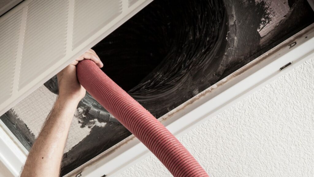 vacuuming cleaning an air duct
