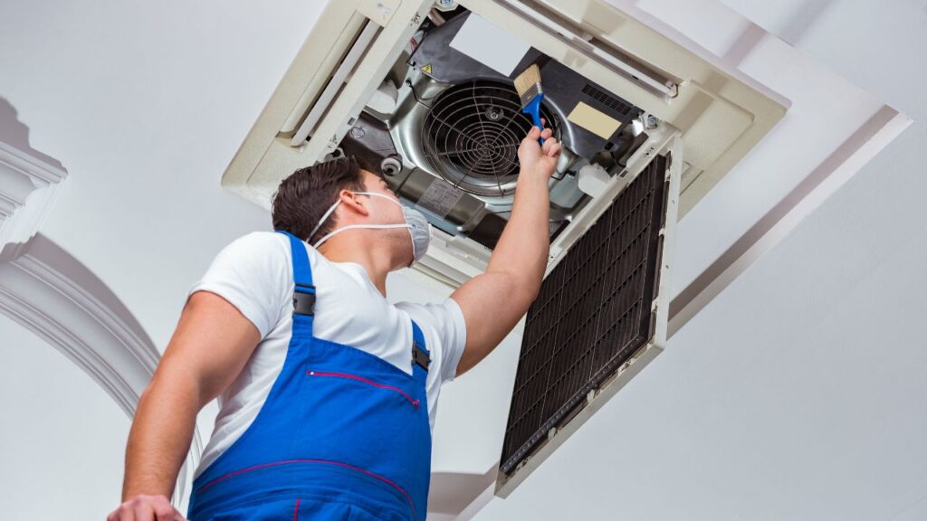 a man maintaining hvac system at home