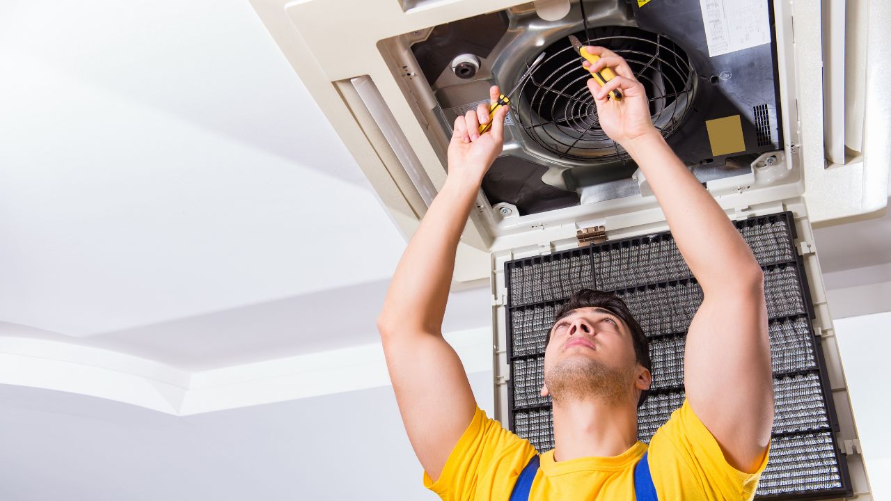 contractor inspecting hvac for cleaning