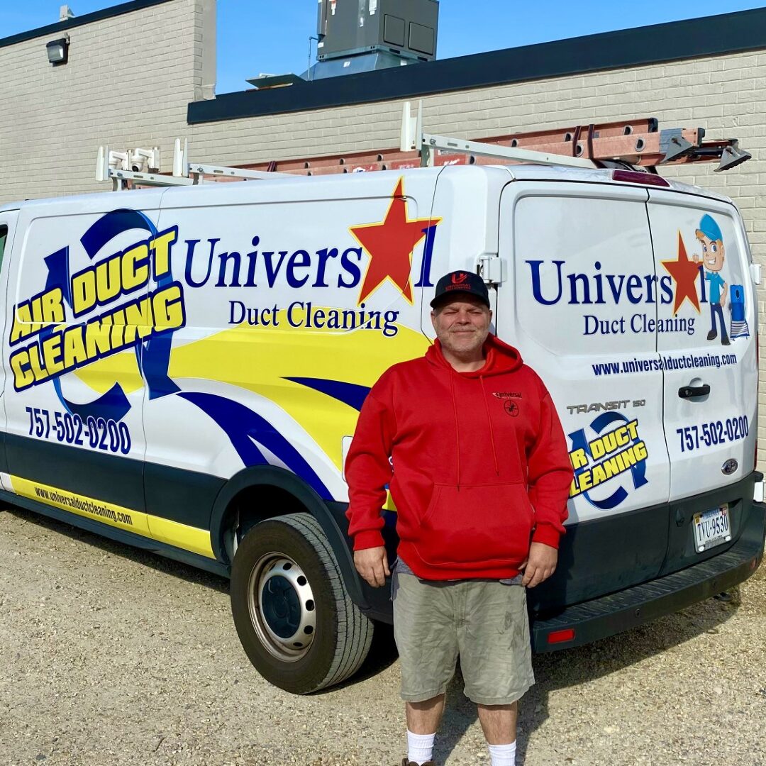 Universal Duct Cleaning technician standing by a service van, serving neighborhoods in Norfolk including Ghent, Ocean View, and Larchmont